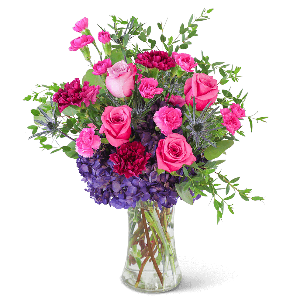 Delight in the rich purple tones of one of our floral favorites, Love in London. A tall, chic vase with hydrangea, roses, carnations, and premium foliage makes up this beautiful floral design. This vibrant flower arrangement will brighten anyone's day and add a pop of color to any space. It would make a perfect Anniversary or Birthday gift for that special someone.