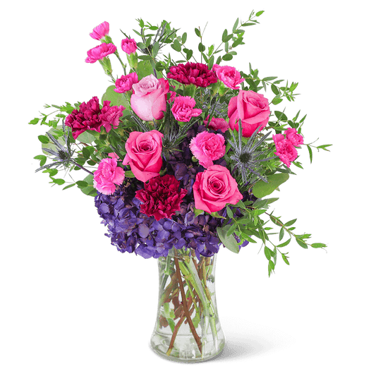 Delight in the rich purple tones of one of our floral favorites, Love in London. A tall, chic vase with hydrangea, roses, carnations, and premium foliage makes up this beautiful floral design. This vibrant flower arrangement will brighten anyone's day and add a pop of color to any space. It would make a perfect Anniversary or Birthday gift for that special someone.