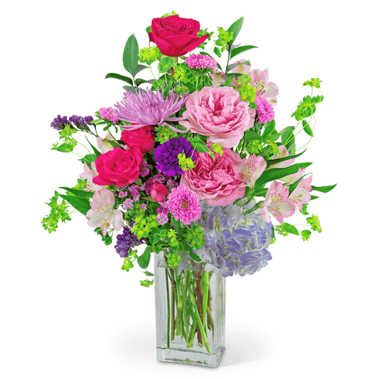 Who wouldn’t love to receive this bright and blooming flower arrangement? Show your Unconditional Love with various light pink and dark pink roses, hydrangea, dianthus, carnations, alstroemeria, spider mums, and premium foliage in a clear vase. This would be a perfect gift for an anniversary, birthday, or Mother's Day and will look perfect on a Dining room table or kitchen bar.