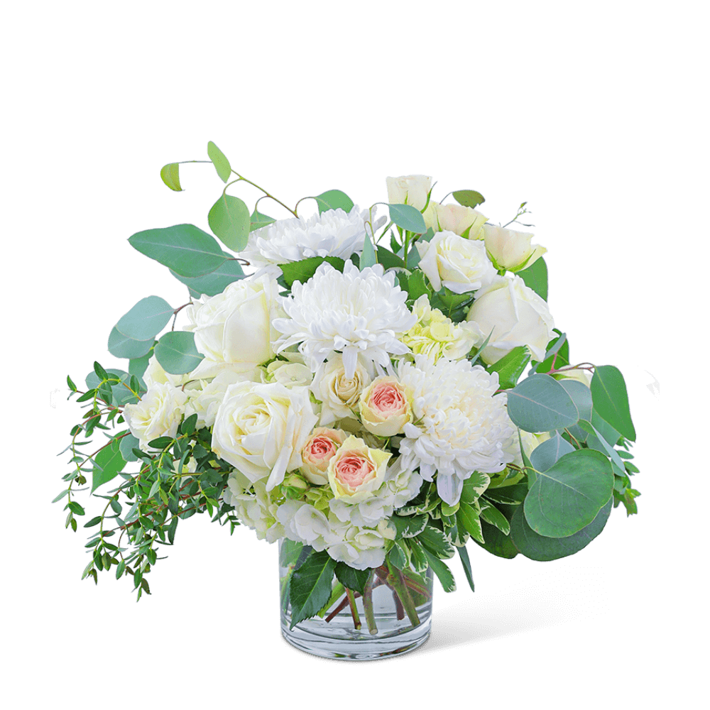 Awaken the senses as you walk into your own romantic floral fantasy! Traditional roses, contemporary mums, and playful hydrangea mix to create a stunning bouquet! Blush Garden is bursting with blossoms and arranged in an eye-catching clear glass vase, accented with premium foliage. A shop favorite, this timeless beauty is perfect for any occasion!