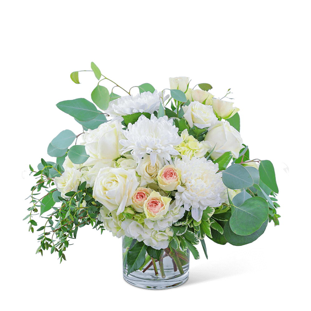 Awaken the senses as you walk into your own romantic floral fantasy! Traditional roses, contemporary mums, and playful hydrangea mix to create a stunning bouquet! Blush Garden is bursting with blossoms and arranged in an eye-catching clear glass vase, accented with premium foliage. A shop favorite, this timeless beauty is perfect for any occasion! 