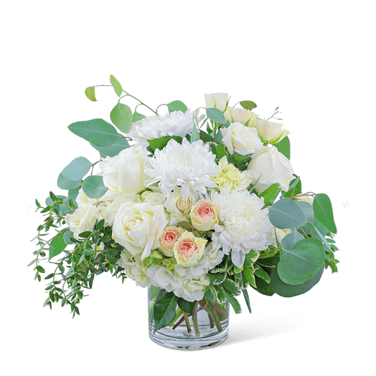 Awaken the senses as you walk into your own romantic floral fantasy! Traditional roses, contemporary mums, and playful hydrangea mix to create a stunning bouquet! Blush Garden is bursting with blossoms and arranged in an eye-catching clear glass vase, accented with premium foliage. A shop favorite, this timeless beauty is perfect for any occasion! 
